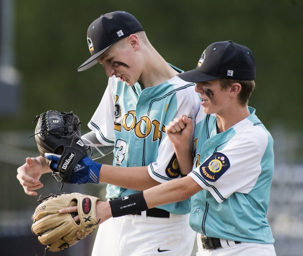 Messalonskee's Mason Violette, left, and Dylan Cunningham celebrate their 6-0 win over Fairfield in the Junior Legion state tournament Monday at Mansfield Stadium in Bangor.