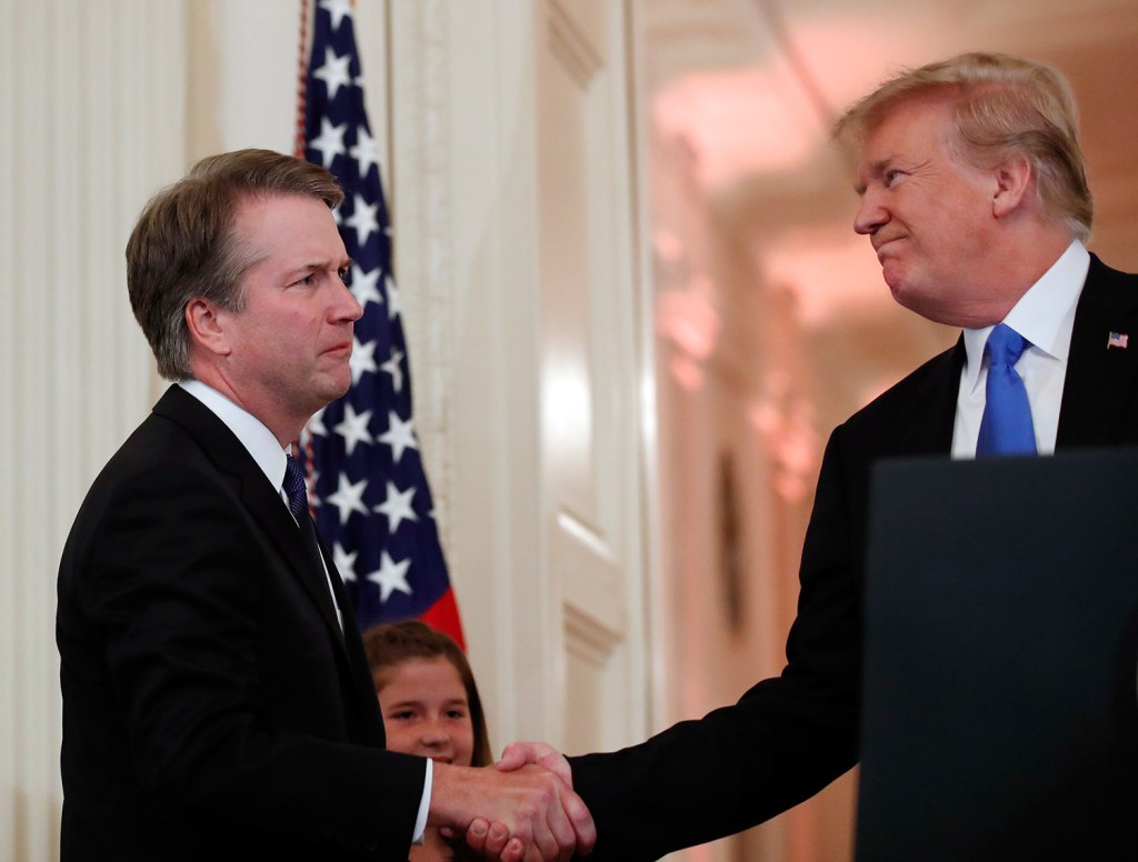 President Trump shakes hands with Judge Brett Kavanaugh his Supreme Court nominee, in the East Room of the White House on Monday night.