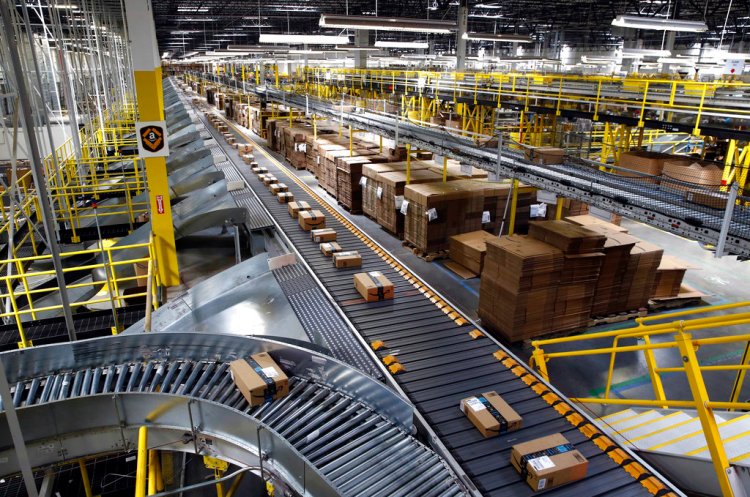 Packages ride a conveyor system at an Amazon fulfillment center in Baltimore. While Amazon doesn't disclose sales figures for Prime Day, one analyst estimates the company generates $3.4 billion in sales worldwide.