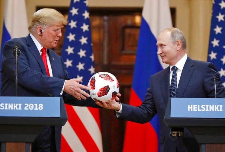 Russian President Vladimir Putin gives a soccer ball to President Trump during a press conference after their meeting at the Presidential Palace in Helsinki, Finland, on July 16, 2018.