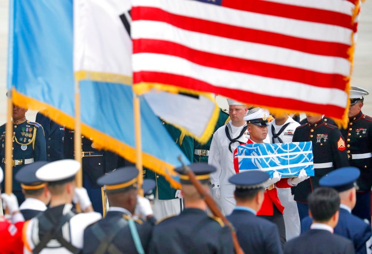 A member of a U.N. honor guard carries a casket containing the possible remains of an American soldier who was killed in the Korean War. The ceremony took place at Osan Air Base in Pyeongtaek, South Korea, Friday. 