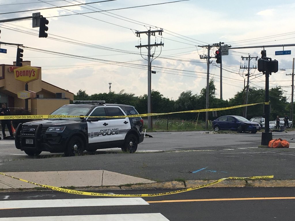 Portland Police investigate the scene of a 3-car crash where one person died at the junction of Riverside Street and Brighton Avenue on Saturday, July 28, 2018.