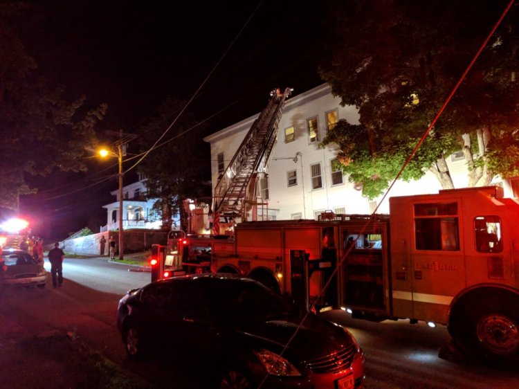 Firefighters investigate a small fire at an apartment house at 18 Bradley St. in Lewiston late Friday night. 

