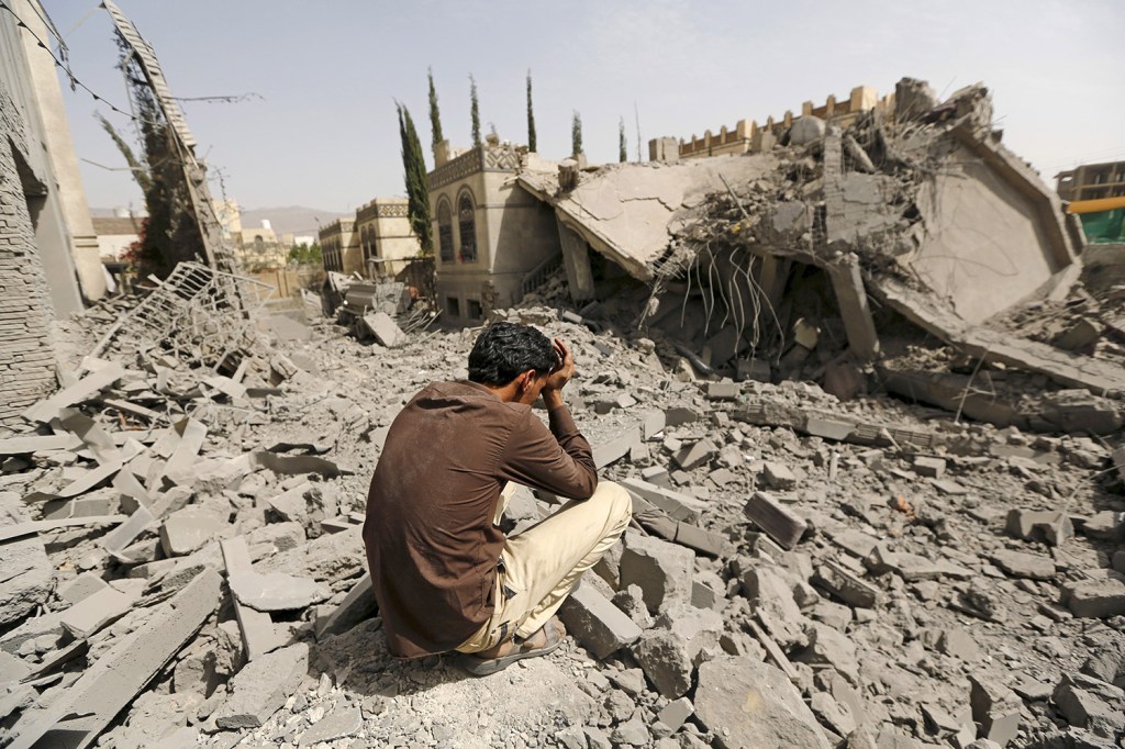 JUNE 15: A guard sits on the rubble of the house of Brigadier Fouad al-Emad, an army commander loyal to the Houthis, after air strikes destroyed it in Sanaa, Yemen. Warplanes from a Saudi-led coalition bombarded Sanaa overnight as the country's warring factions prepared for talks expected to start in Geneva.