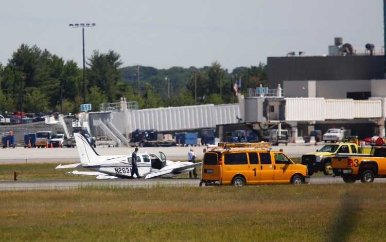 A twin-engine plane landed on its belly at Portland International Jetport on Thursday, causing all runways to close.