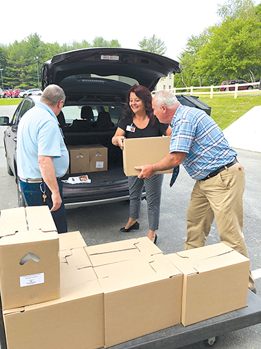 Volunteers unload Emergency Food Kits from Good Shepherd Food Bank for use at Inland Hospital physician practices. Contributed photo