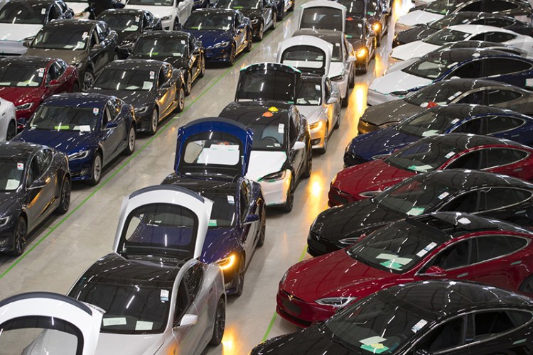 A line of new Tesla Model X sports utility vehicles, center, sit with Tesla Model S automobiles following assembly for the European market at the Tesla factory in Tilburg, Netherlands, on Dec. 9, 2016. 
