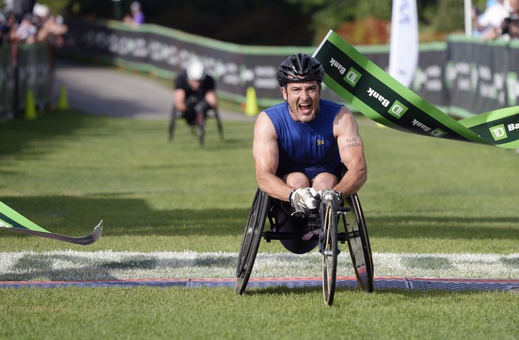 Tony Nogueira of New Jersey crosses the finish line to win the wheelchair division of the Beach to Beacon on Saturday.