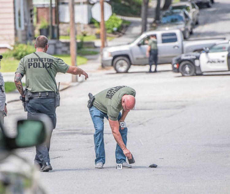 Lewiston police pick up evidence on Bradley Street after a shooting was reported Thursday afternoon. Statistically, crime is down in Lewiston. But tension and unease are high after a pair of recent homicides.