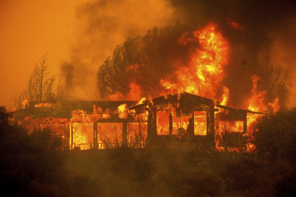 A home burns as the River Fire rages near Finley, Calif., on July 30.