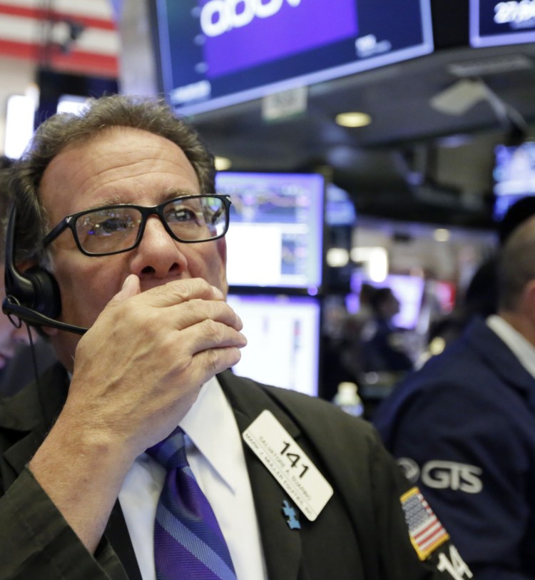 Trader Sal Suarino works the floor of the New York Stock Exchange on a positive day for the markets.