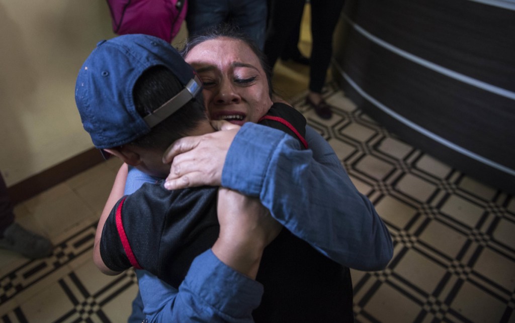 Lourdes de Leon hugs her son Leo Jeancarlo de Leon, 6, as they are reunited in Guatemala City on Tuesday. The Trump administration has been ordered to return more than 2,500 separated children back to their families, but hundreds remain apart after the deadline.
