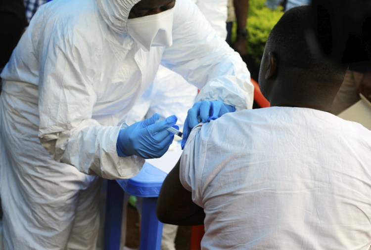 A healthcare worker from the World Health Organization gives an Ebola vaccination to a front line aid worker in Mangina, Democratic Republic of Congo on Wednesday.