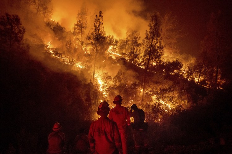 Firefighters monitor a backfire while battling the Ranch Fire, part of the Mendocino Complex, on Tuesday near Ladoga, Calif.