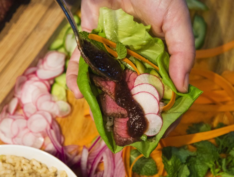 Once reduced, ketjap marinade becomes a flavorful sauce to be drizzled on lettuce wraps.