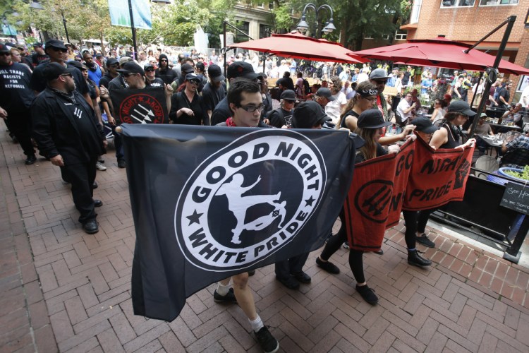 A group of anti-fascism demonstrators march in downtown Charlottesville, Va., on Saturday in anticipation of the anniversary of last year's "Unite the Right" protest that killed one.