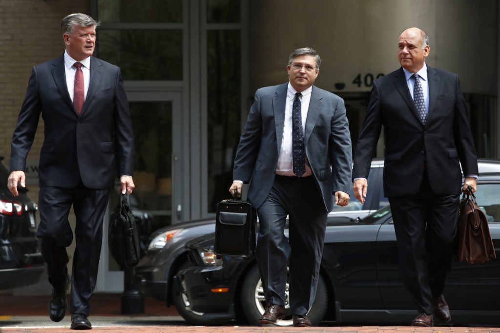 Members of the defense team for Paul Manafort, including Kevin Downing, left, Richard Westling, and Thomas Zehnle, walk to federal court as the trial of the former Trump campaign chairman continues, in Alexandria, Va., on Monday. The prosecution rested its case in the fraud trial Monday.