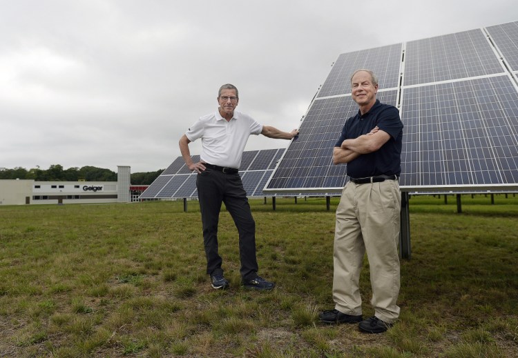 Brothers Gene, left, and Peter Geiger stand near the solar panels at Geiger in Lewiston. The Geigers publish the Farmers' Almanac.
