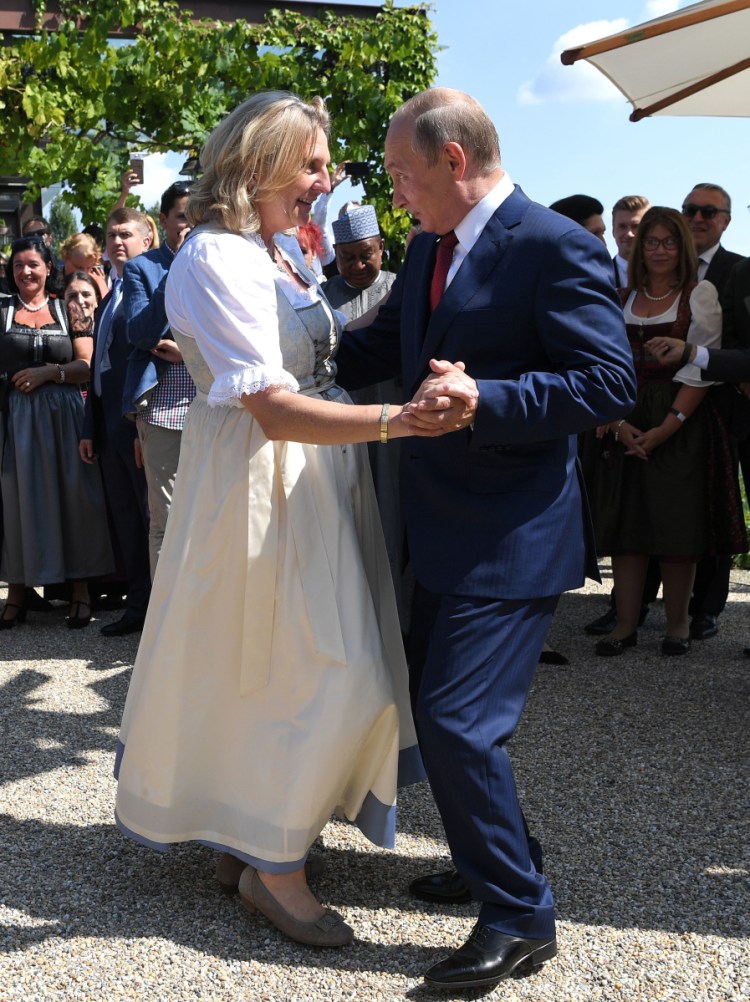 Russian President Vladimir Putin dances with Austrian Foreign Minister Karin Kneissl at her wedding in Gamlitz, southern Austria, on Saturday. He brought a small Cossack men's choir along to entertain about 100 guests.
