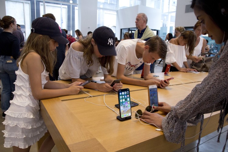 Customers browse in an Apple store in New York. 