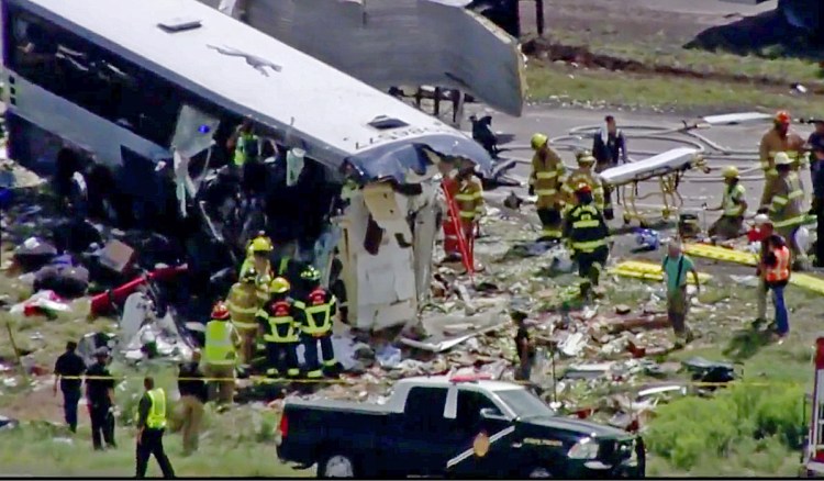 First responders work at the scene of a collision between a Greyhound passenger bus and a semitruck on Interstate 40 near the town of Thoreau, N.M., on Thursday.
