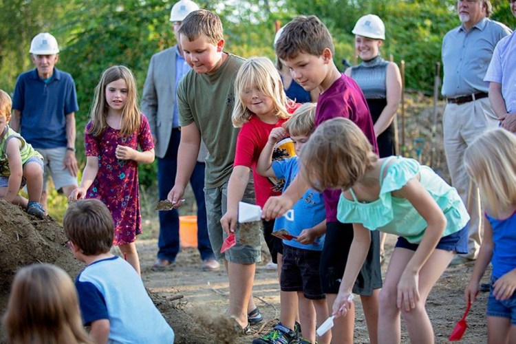 Monmouth students help break ground on the town's new middle-elementary school on the evening of July 31. The school, which is expected to open in January 2020, is being mostly funded by the state.