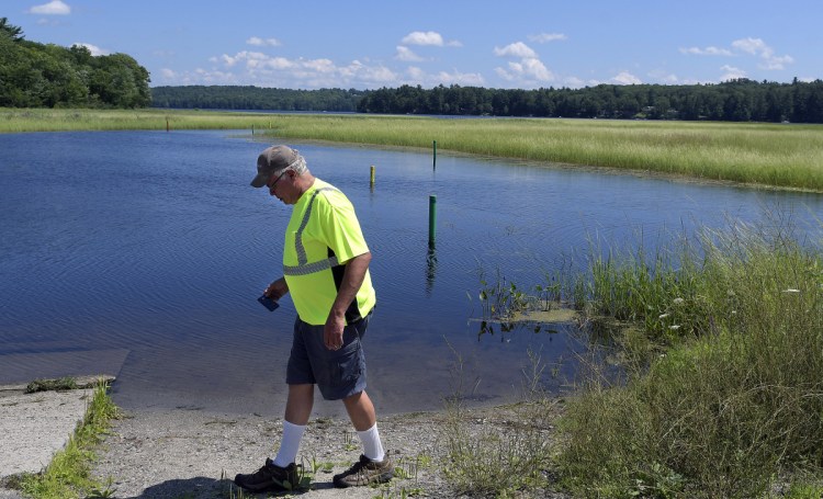 Monmouth Public Works Director Bruce Balfour on Thursday walks along the boat launch on Annabessacook Lake on Waugan Road in Monmouth. Town selectmen have voted to close the boat ramp temporarily because of the presence there of variable-leaf milfoil, pending a legal consultation.