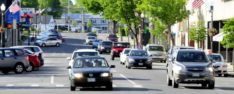 Traffic moves through downtown Waterville on one-way Main Street on June 1, 2014. The City Council on Monday is expected to consider entering into a $400,000 contract with the state Department of Transportation and Colby College for preliminary engineering needed to start a discussion about whether to have two-way traffic on Main and Front streets downtown.