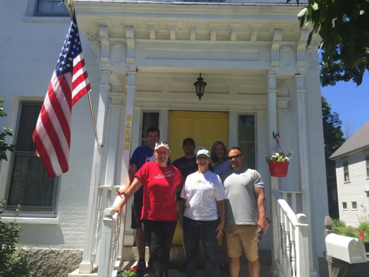Wells Fargo employees from around Maine gather July 19 on the front steps of the Betsy Ann Rose House of Hope, in Augusta, where they spent the day cleaning up the third floor of the home, removing debris and building baseboards for a new bathroom, to help create additional living space so the shelter can serve more veterans and help them transition to permanent, independent housing. In front from left are Katy Wood, Wells Fargo community banking; Martha St. Pierre, Betsy Ann Rose House of Hope executive director; and Michael Sargent, Wells Fargo adviser. In back, from left, are Rob Small, Wells Fargo middle market banking; Ben Smith, Wells Fargo adviser; and Terry Simms, Wells Fargo adviser.