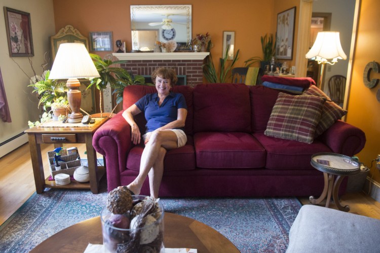 Cathy Taylor shows her home which is up for sale on Merrill Street in Waterville on Saturday.
