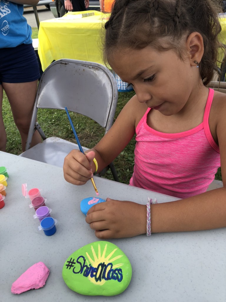 Avery Charland, of Fairfield, was among hundreds of kids who painted positive messages on rocks to hide in the community to spread kindness as part of the July 28 ShineOn Oakland Day at Oakfest.