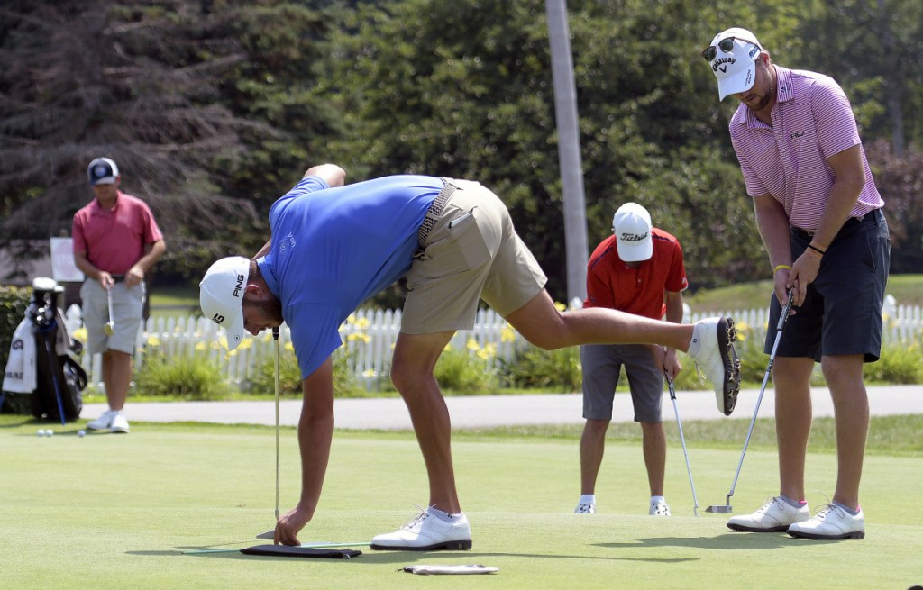 Golfers work on their putting during a Pro-Am event Monday at the Augusta Country Club in advance of the Charlie's Maine Open that starts Tuesday.