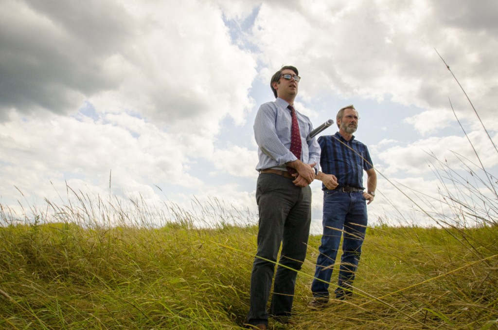 Garvan Donegan, Central Maine Growth Council senior economic development specialist, left, and Greg Brown, Waterville city engineer, survey the landfill off Webb Road in Waterville in August 2017. Plans are are moving forward in the development of a 20-megawatt solar farm on the site that could power 3,750 homes.