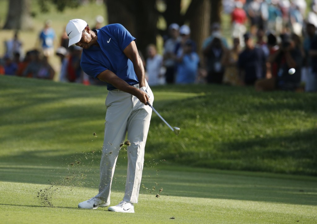 Tiger Woods hits to the 18th green during the third round of the PGA Championship on Saturday in St. Louis.