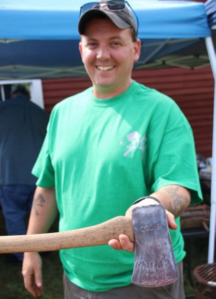 Mike Fraser, of Sanford, an organizer of the Maine Axe & Saw Meet Up that took place in Waterboro on Saturday, displays an axe in his collection inscribed CCC-S, which means it was a Civilian Conservation Corps axe used on a state project. The CCC was established by President Franklin Delano Roosevelt in 1933 to provide work to the unemployed during the Great Depression.