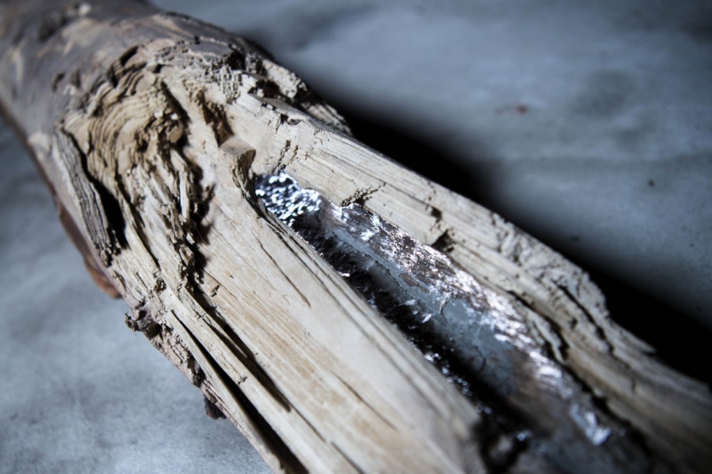 Gary Cowan, an operator at the Skowhegan water treatment plant, holds a piece of a 150-year-old wooden water pipe Wednesday that was discovered recently in Skowhegan.