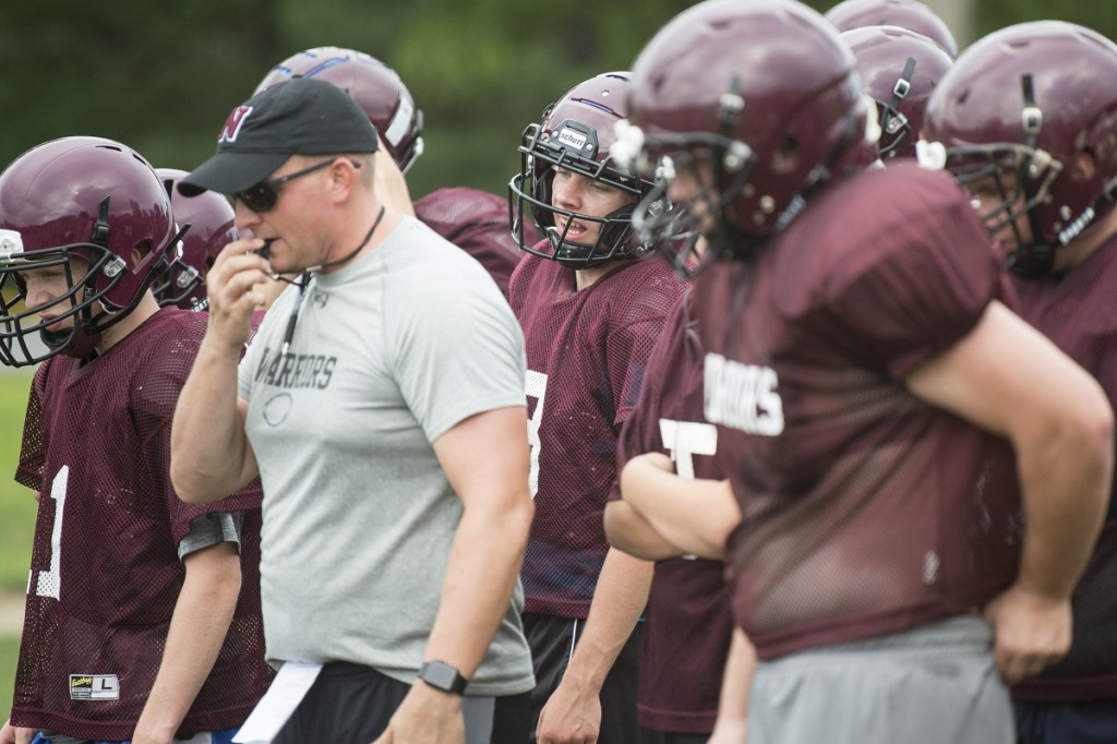 Staff photo by Michael G. Seamans 
 Nokomis quarterback Andrew Haining center, calls out snap counts as head coach Jake Rogers blows the whistle during practice Wednesday in Newport.