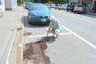 Susun Terese, owner of Minikins on Broadway in Farmington, says she was surprised Friday morning when she saw dirt and remnants of some of her petunias in the street. Vandals turned over trash cans and flower pots in front of downtown businesses, and did damage early Friday at the University of Maine at Farmington.