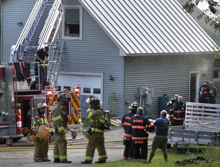 Firefighters from several communities extinguish a blaze Tuesday at a residence on Indiana Road in West Gardiner.