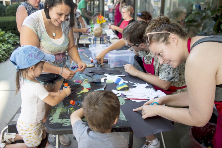 Maya Bernardini, 2, left, and her big brother CJ, 4, center, work on arts and crafts Thursday with their mother, Erika Bernardini, back left, and Dianna Wendell, right, an educator at Common Street Arts, during an art party at The Center at Castonguay Square in downtown Waterville. Waterville Creates! and Common Street Arts are moving temporarily to the Hathaway Creative Center to make way for long-term changes at The Center on Main Street.