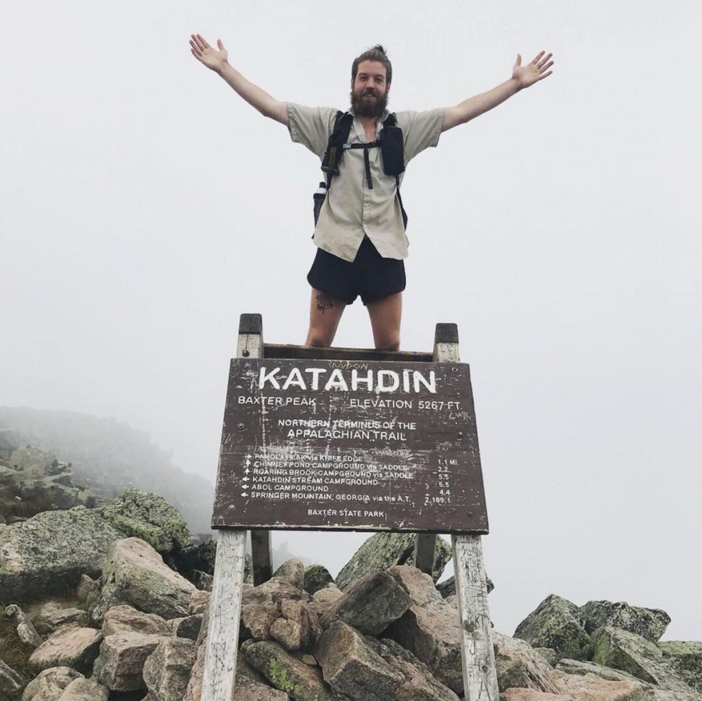 Sam Hopkins stands atop Mt. Katahdin after competing his trek up the Appalachian Trail.
