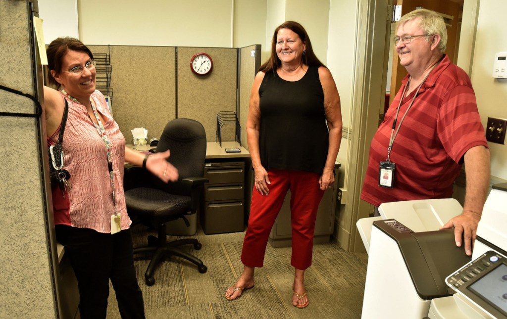 The Somerset Career Center has moved from Skowhegan into the Averill building on the Alfond Campus of Kennebec Valley Community College at Good Will-Hinckley in Fairfield, where it was open for business on Monday. Assistant Director Linda Price, center, talks with Department of Labor employees Jennifer Smith and Craig Barrows.