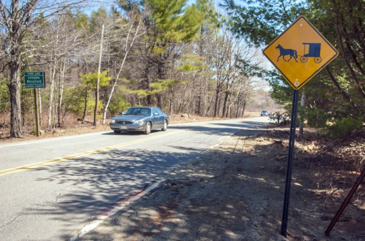 A horse-and-buggy sign stands in 2017 at Whitefield's border with Pittston on Route 194.