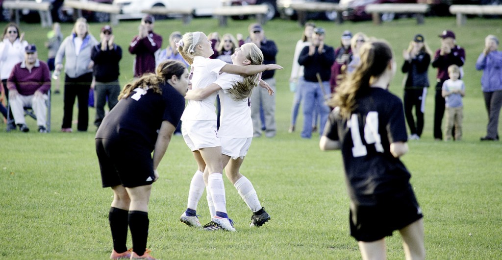 Big goal: Monmouth's Audrey Fletcher, center left, celebrates with teammate Alicen Burnham after Burnham scored a goal against St. Dominic in a Class C South semifinal game last season in Monmouth.