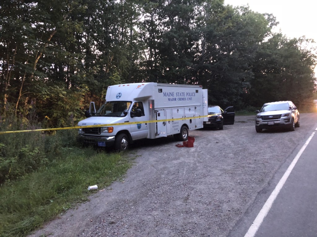 A Maine State Police major crimes van is parked at the side of Weeks Mills Road in Augusta, near where a body was found Aug. 23.