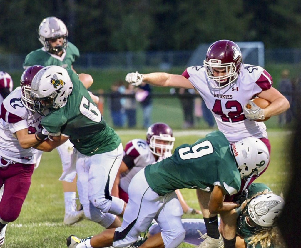 Maine Central Institute's Tucker Sharples gets tackled by Leavitt's Damion Calder during the season opener Friday night in Turner.