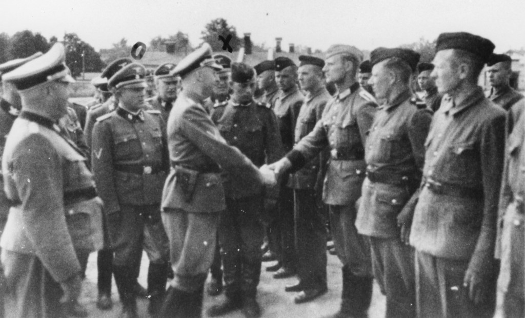 This 1942 photo provided by the the public prosecutor's office in Hamburg via the United States Holocaust Memorial Museum, shows Heinrich Himmler, center left, shaking hands with new guard recruits at the Trawniki concentration camp in Nazi occupied Poland. Trawniki is the same camp, where some time after this photo was made, Jakiw Palij trained and served as a guard.  