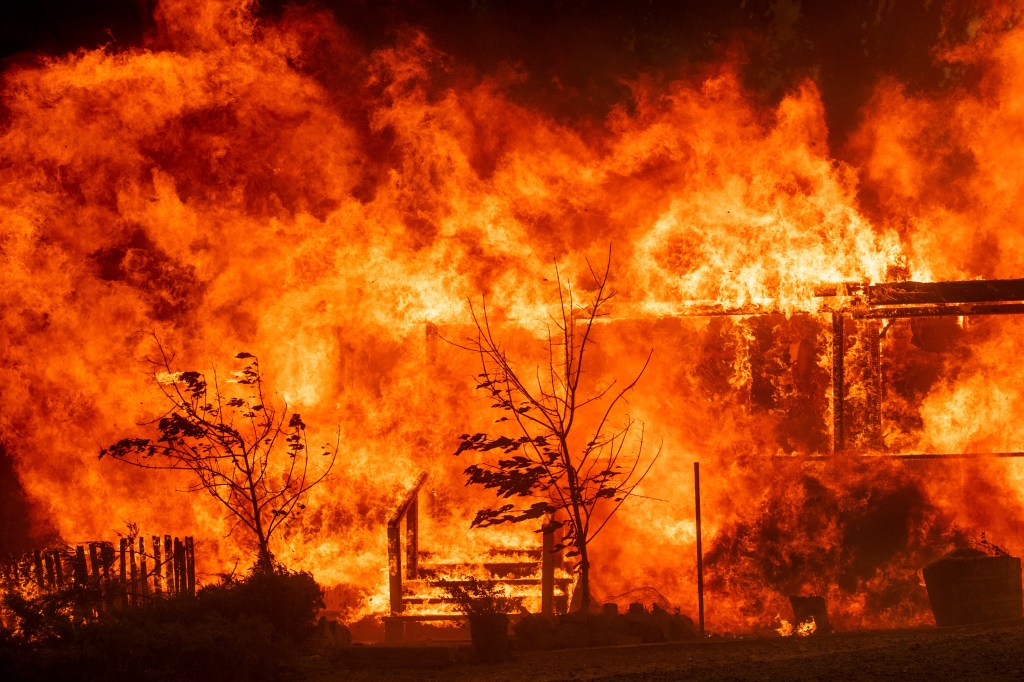 Flames consume a home as the River Fire tears though Lakeport, Calif., on Tuesday, July 31, 2018. 