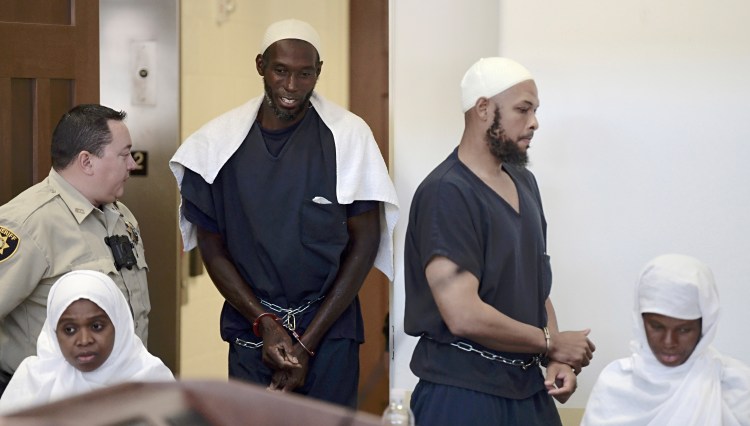 Defendants, from left, Jany Leveille, Lucas Morton, Siraj Wahhaj and Subbannah Wahhaj enter district court in Taos, N.M., for a detention hearing Monday. Several defendants have been charged with child abuse stemming from the alleged neglect of 11 children found living on a squalid compound on the outskirts of tiny Amalia, New Mexico.