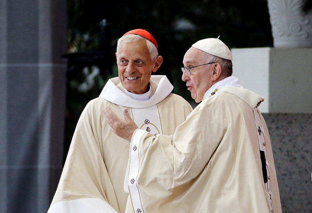 In this Sept. 23, 2015, file photo, Cardinal Donald Wuerl, archbishop of Washington, left, looks toward the crowd with Pope Francis following a Mass outside the Basilica of the National Shrine of the Immaculate Conception in Washington. Wuerl wrote to priests to defend himself on the eve of the scheduled Tuesday, Aug. 14, 2018, release of a grand jury report investigating child sexual abuse in six of Pennsylvania's Roman Catholic dioceses.